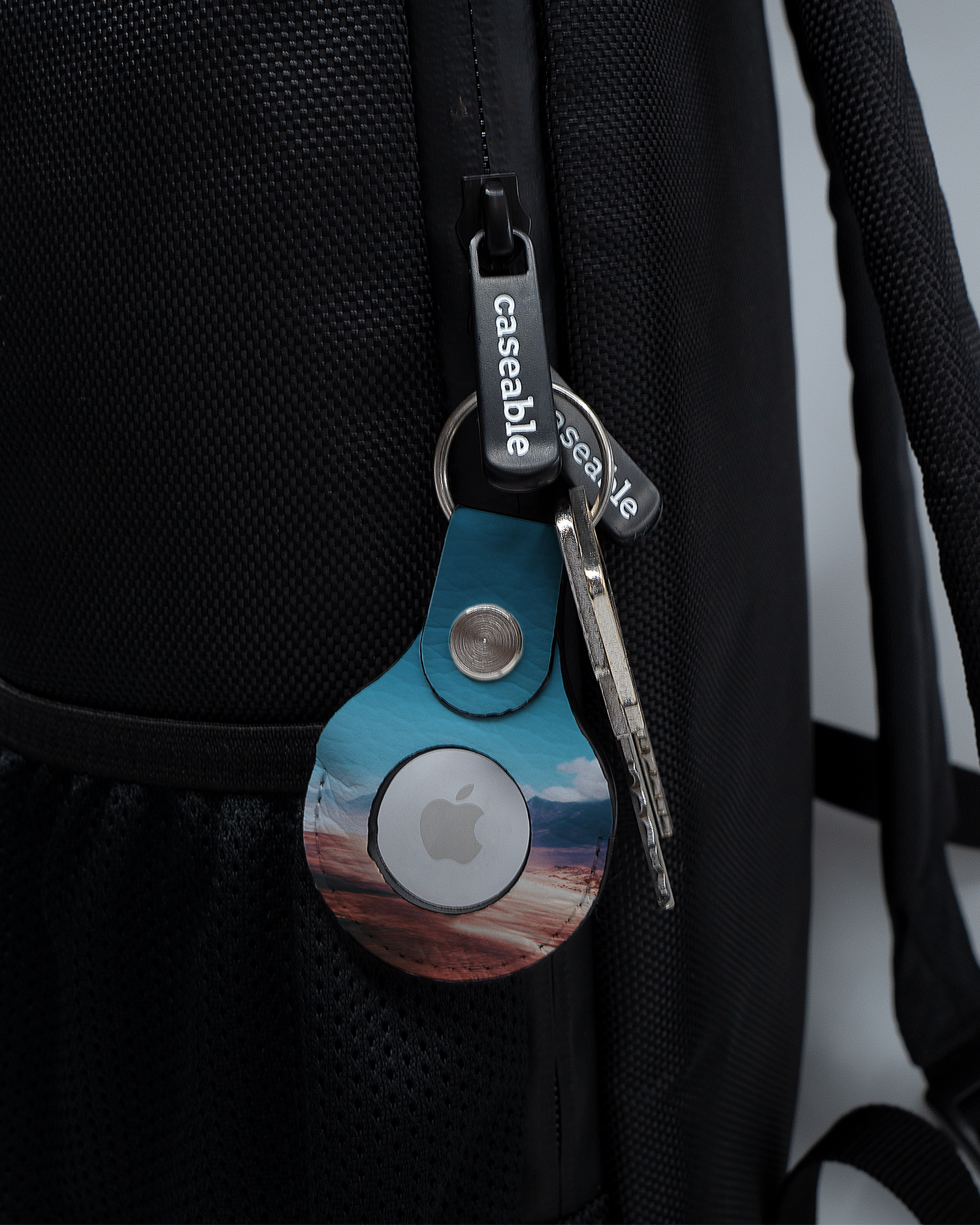 AirTag Holder with design Sky attached to a bag