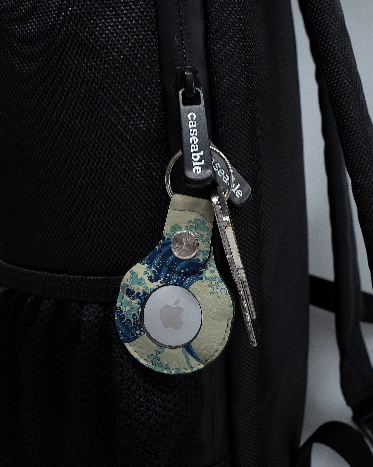 AirTag Holder with design Great Wave Off Kanagawa By Hokusai attached to a bag