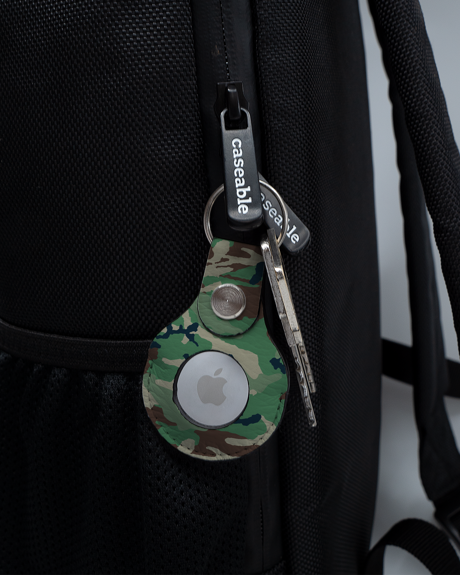 AirTag Holder with design Green and Brown Camo attached to a bag
