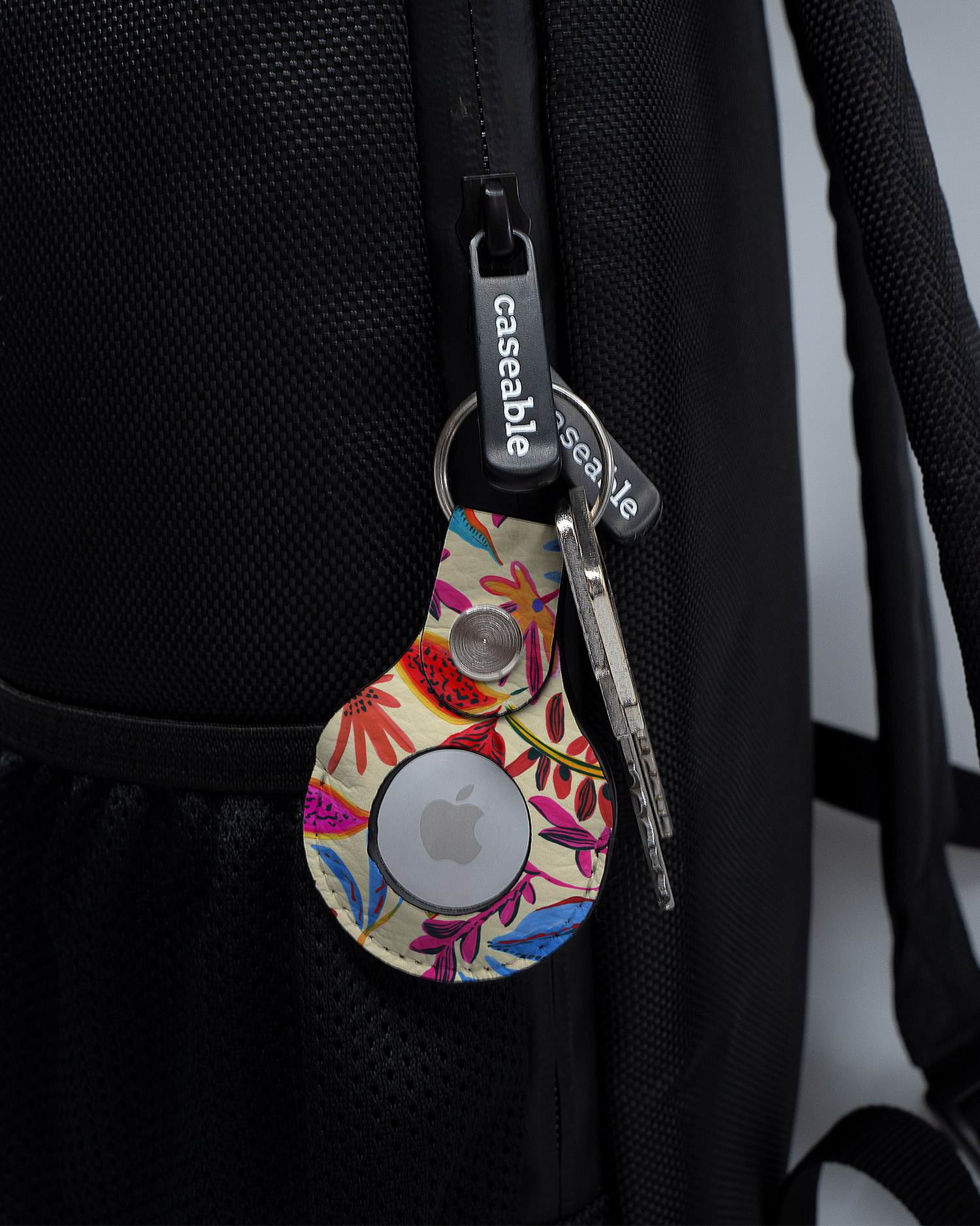 AirTag Holder with design Painterly Spring Leaves attached to a bag