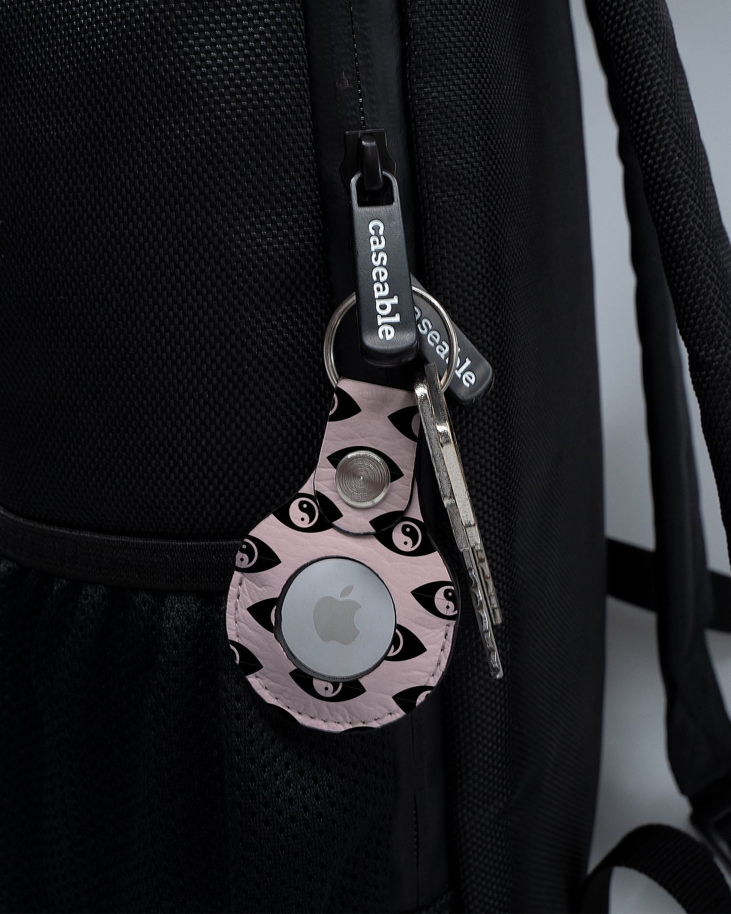 AirTag Holder with design Yin Yang Repeat attached to a bag