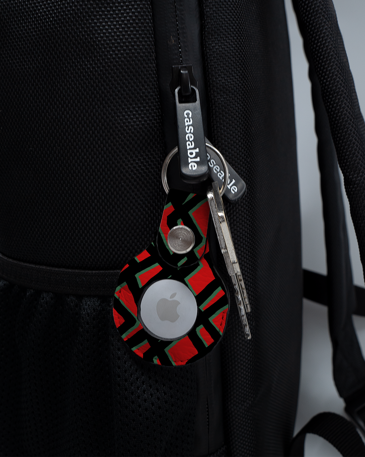 AirTag Holder with design Fences Pattern attached to a bag