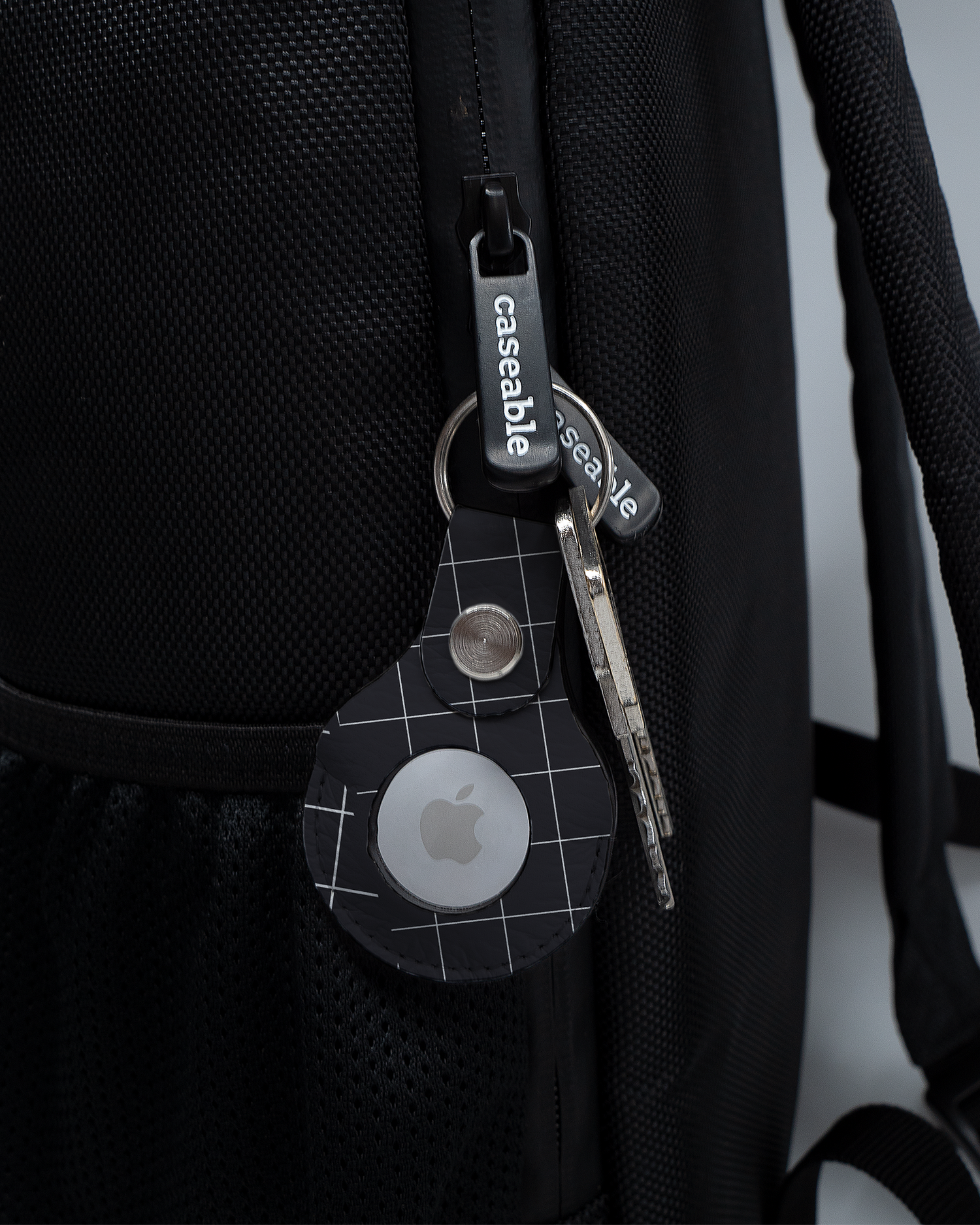 AirTag Holder with design Grids attached to a bag
