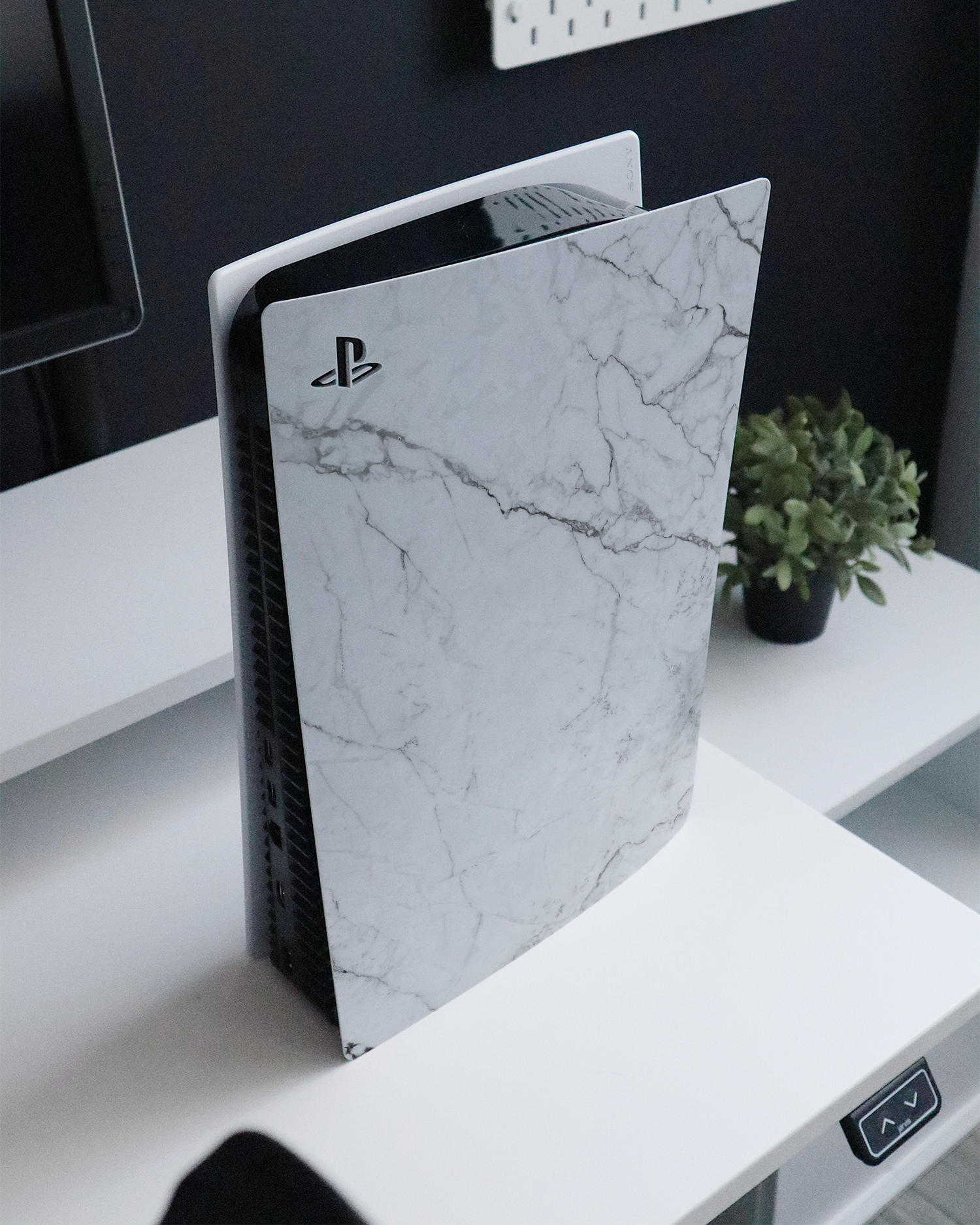 White Marble Console Skin for Sony PlayStation 5 Digital Edition standing on a sideboard 