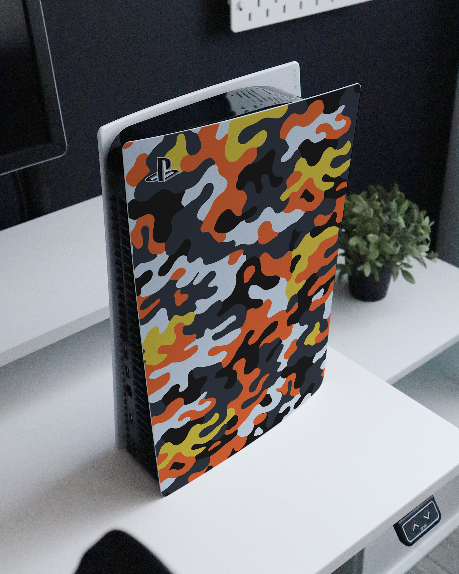 Colourful Camo Console Skin for Sony PlayStation 5 Digital Edition standing on a sideboard 