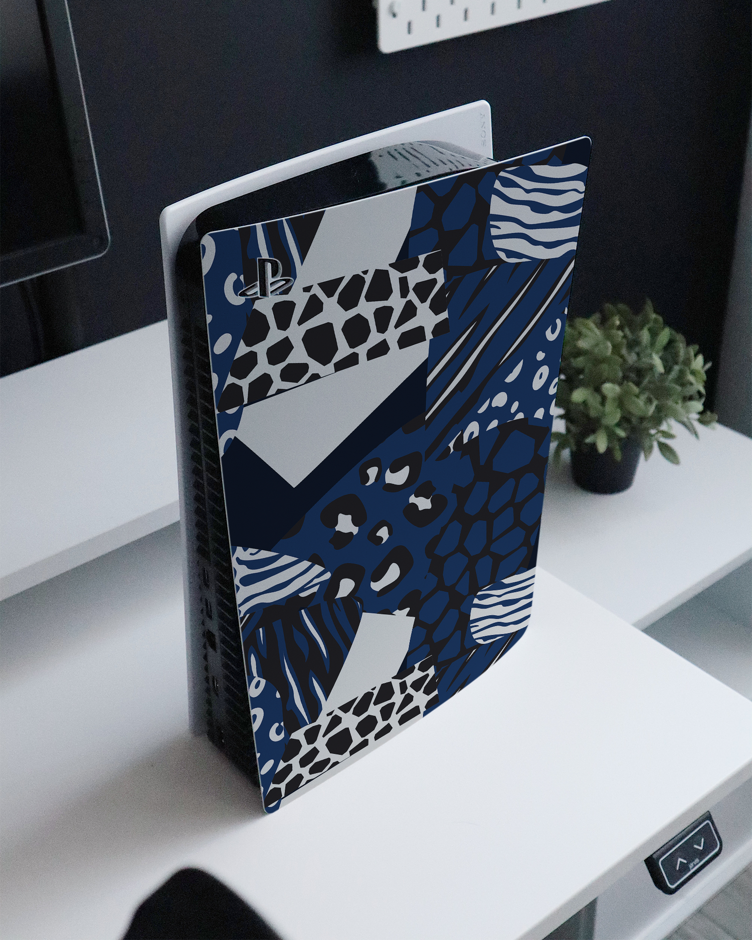 Animal Print Patchwork Console Skin for Sony PlayStation 5 Digital Edition standing on a sideboard 