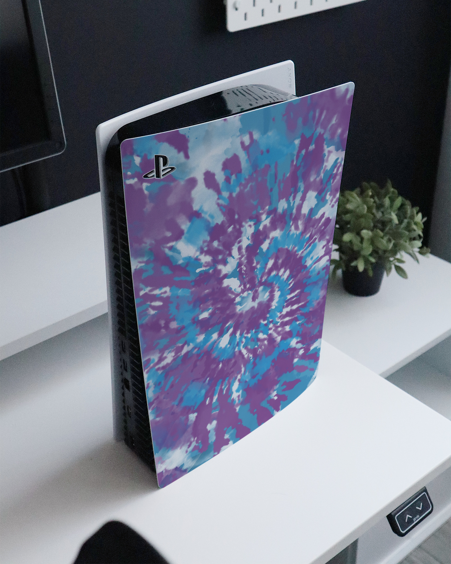 Classic Tie Dye Console Skin for Sony PlayStation 5 Digital Edition standing on a sideboard 