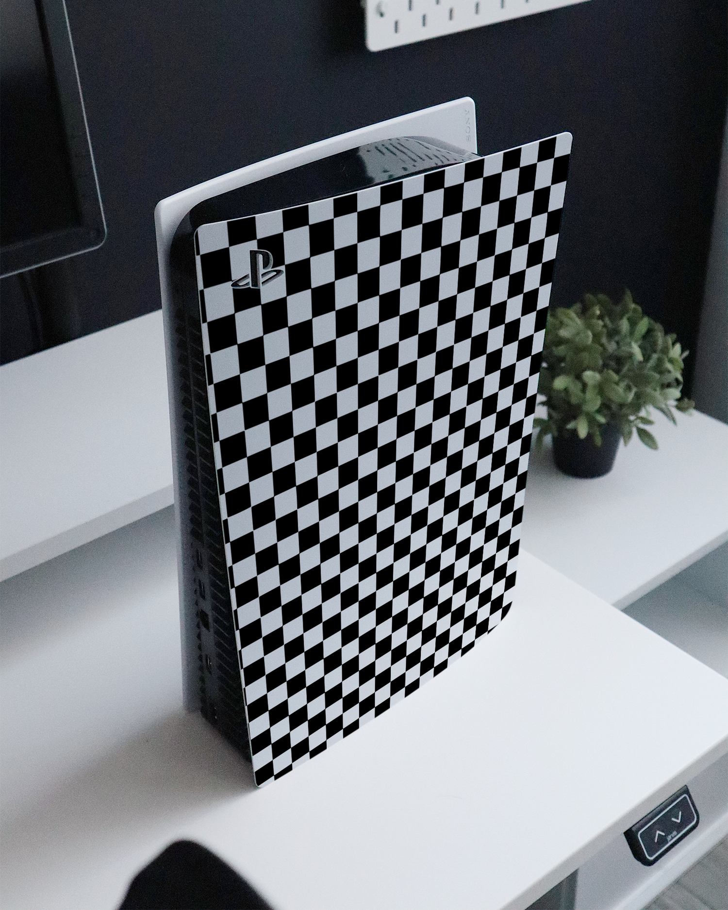 Squares Console Skin for Sony PlayStation 5 standing on a sideboard 
