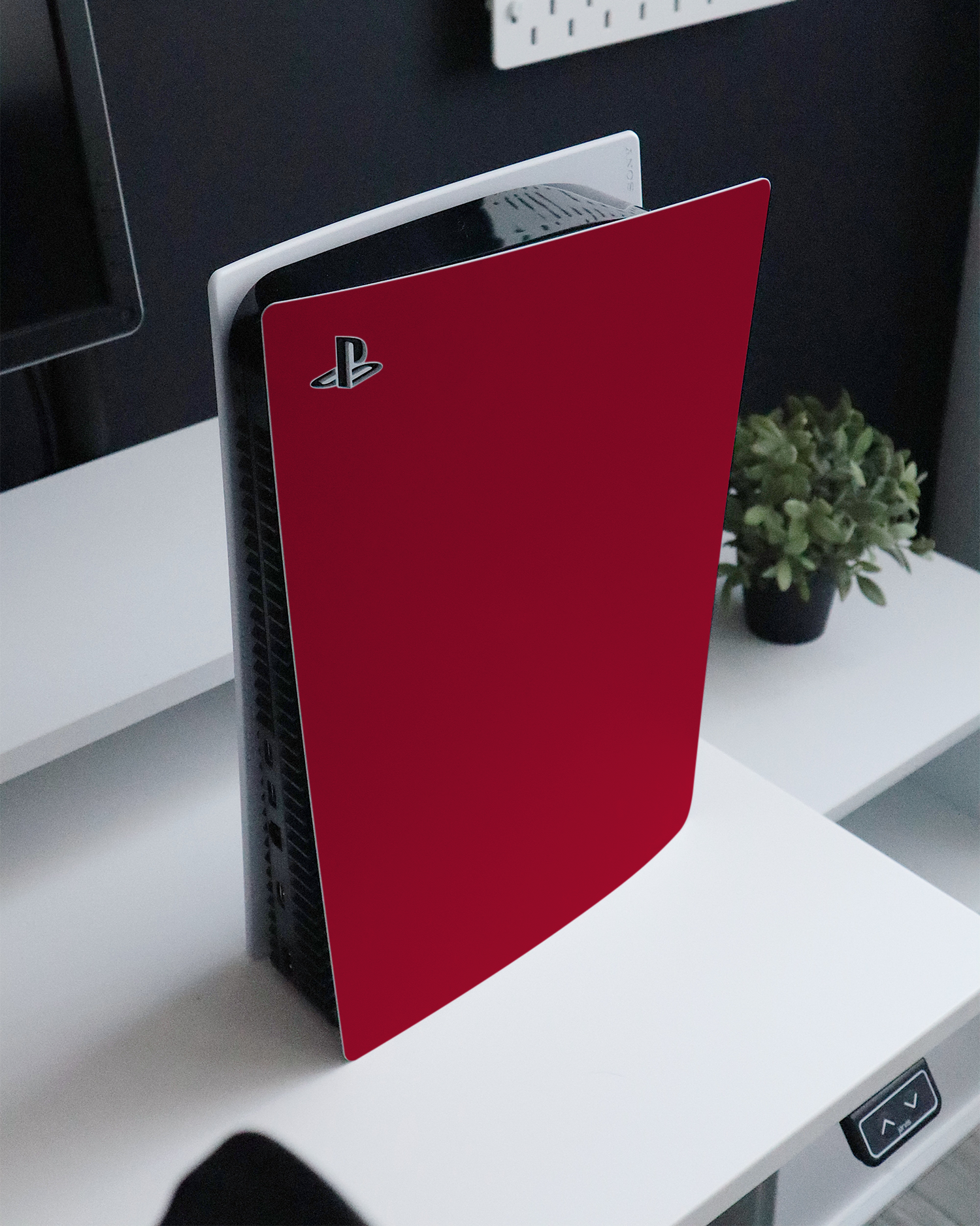 RED Console Skin for Sony PlayStation 5 standing on a sideboard 