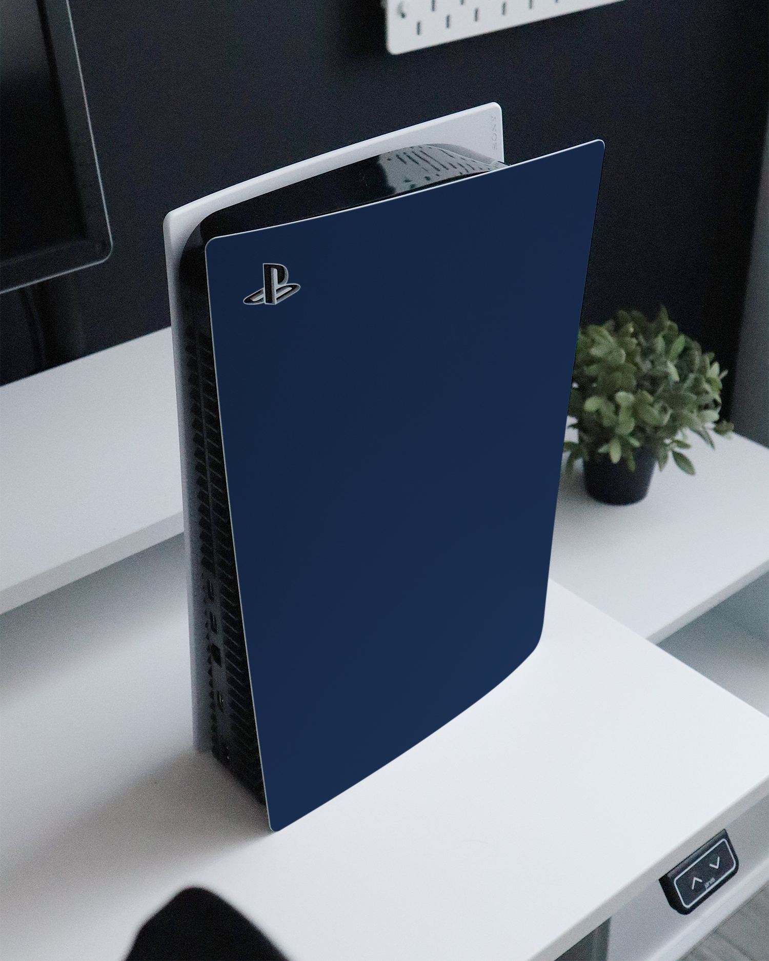 NAVY Console Skin for Sony PlayStation 5 standing on a sideboard 