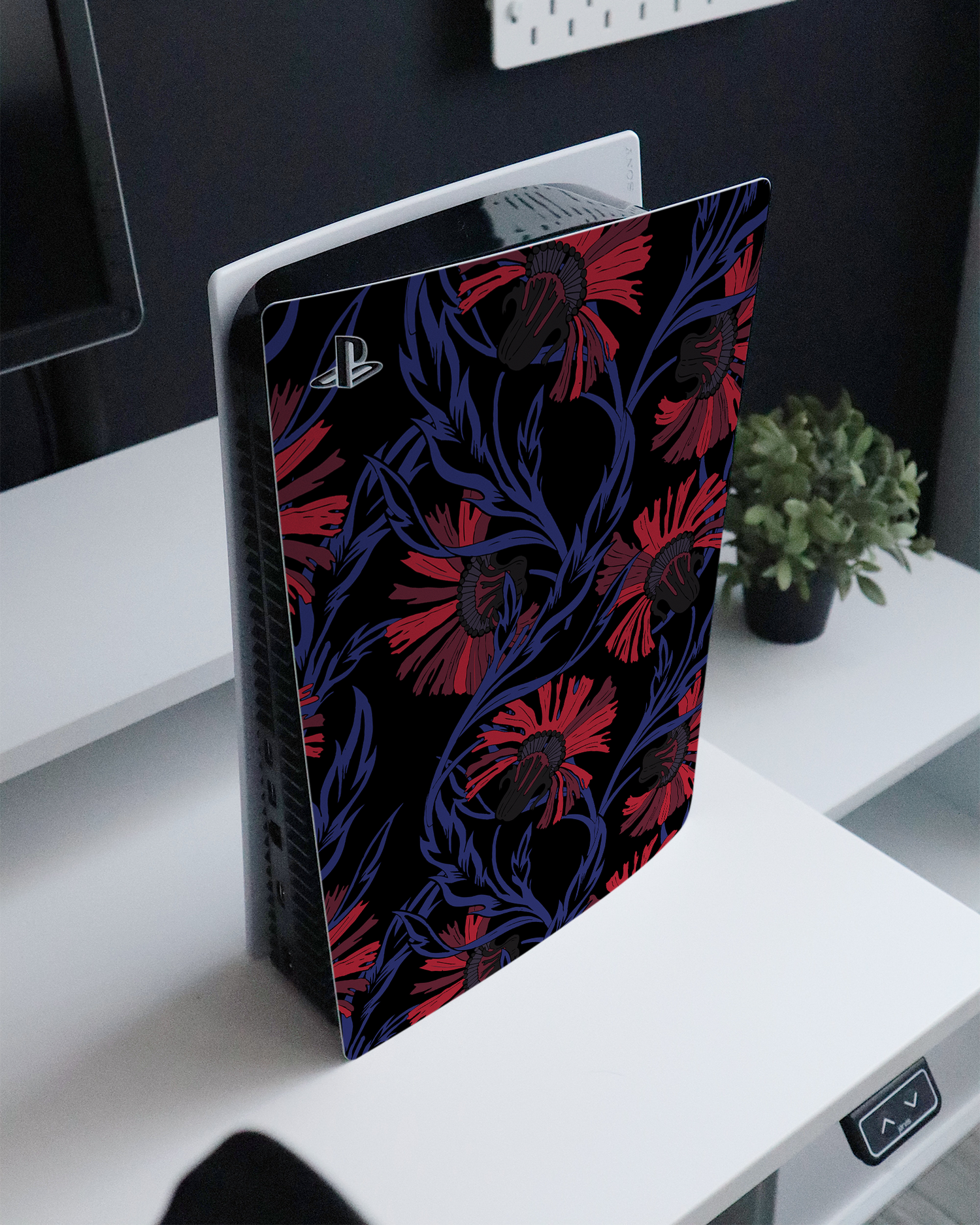 Midnight Floral Console Skin for Sony PlayStation 5 standing on a sideboard 