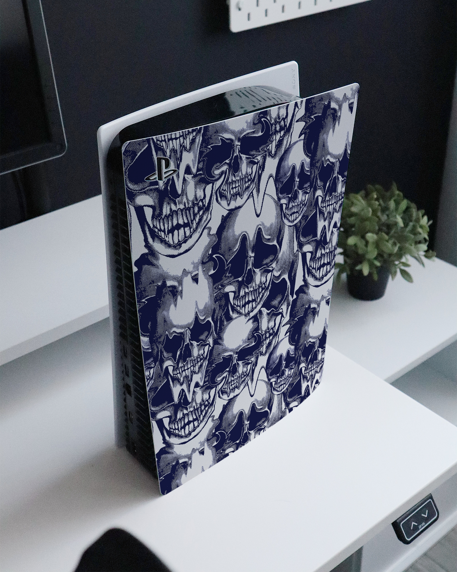 Warped Skulls Console Skin for Sony PlayStation 5 standing on a sideboard 