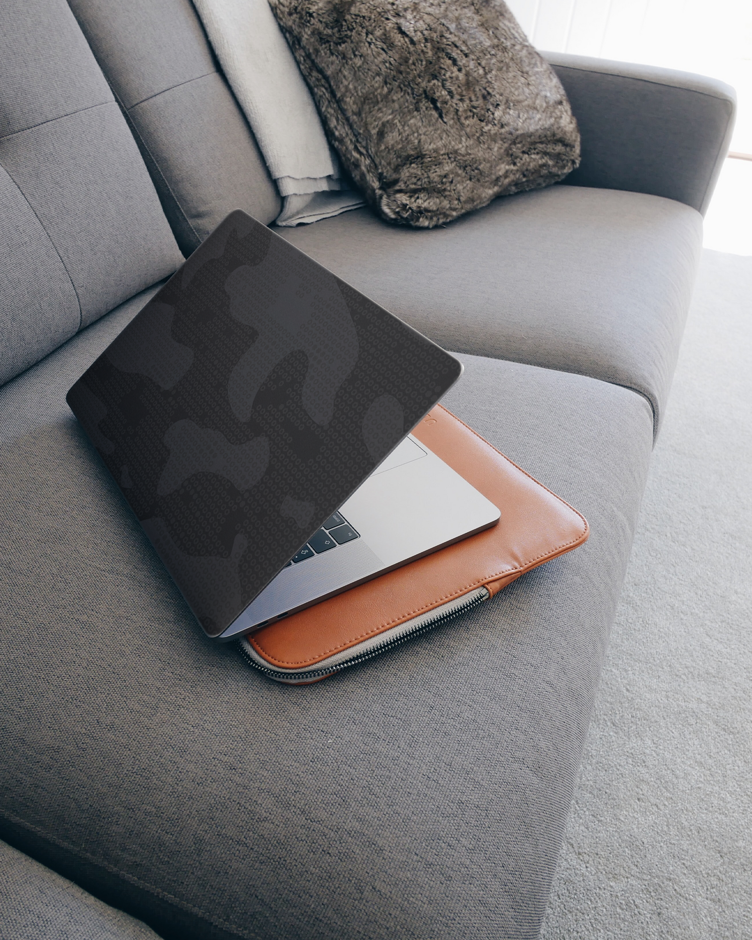 Spec Ops Dark Laptop Skin for 15 inch Apple MacBooks on a couch