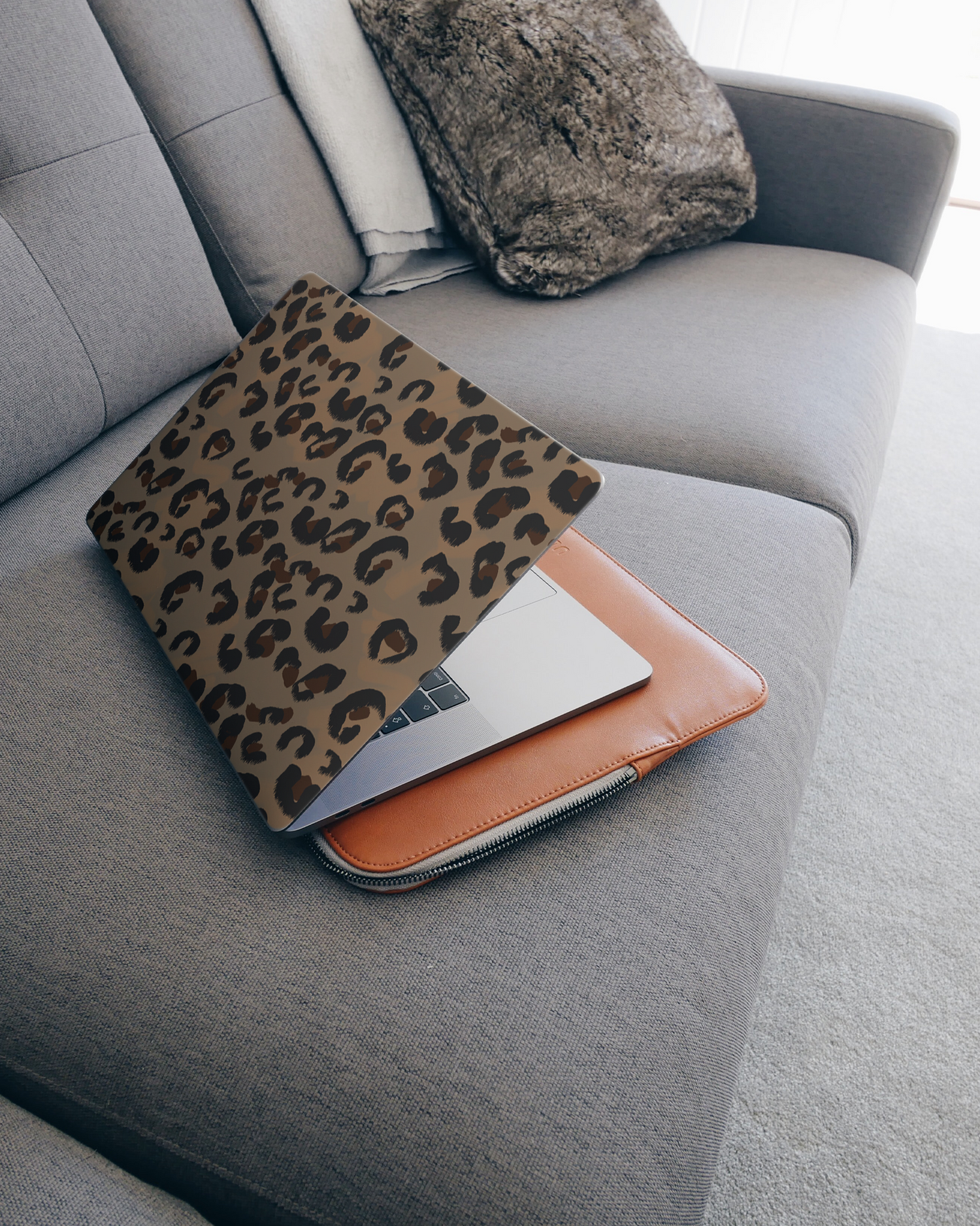 Leopard Repeat Laptop Skin for 15 inch Apple MacBooks on a couch