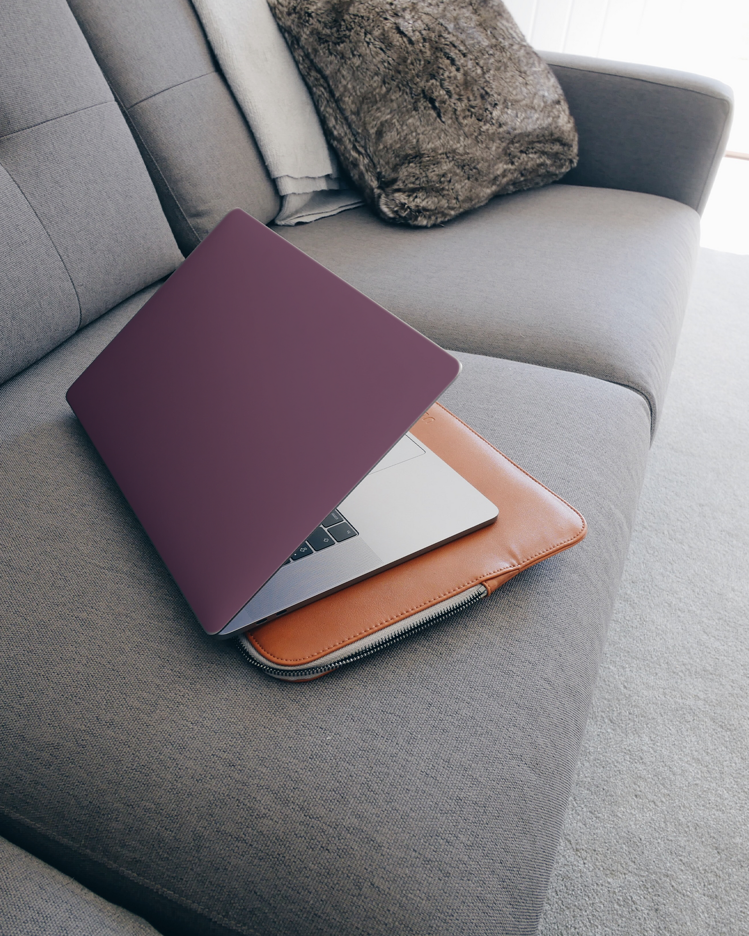 PLUM Laptop Skin for 15 inch Apple MacBooks on a couch
