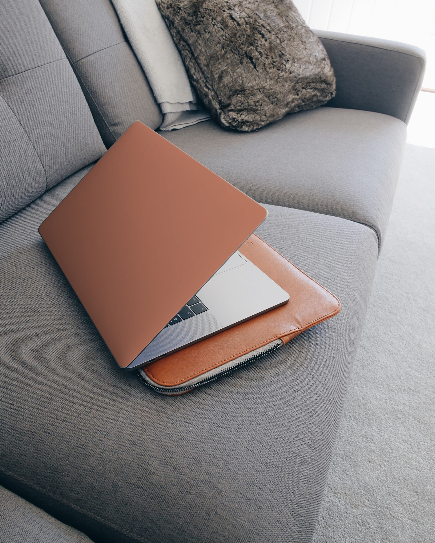 DUSTY CLAY Laptop Skin for 15 inch Apple MacBooks on a couch