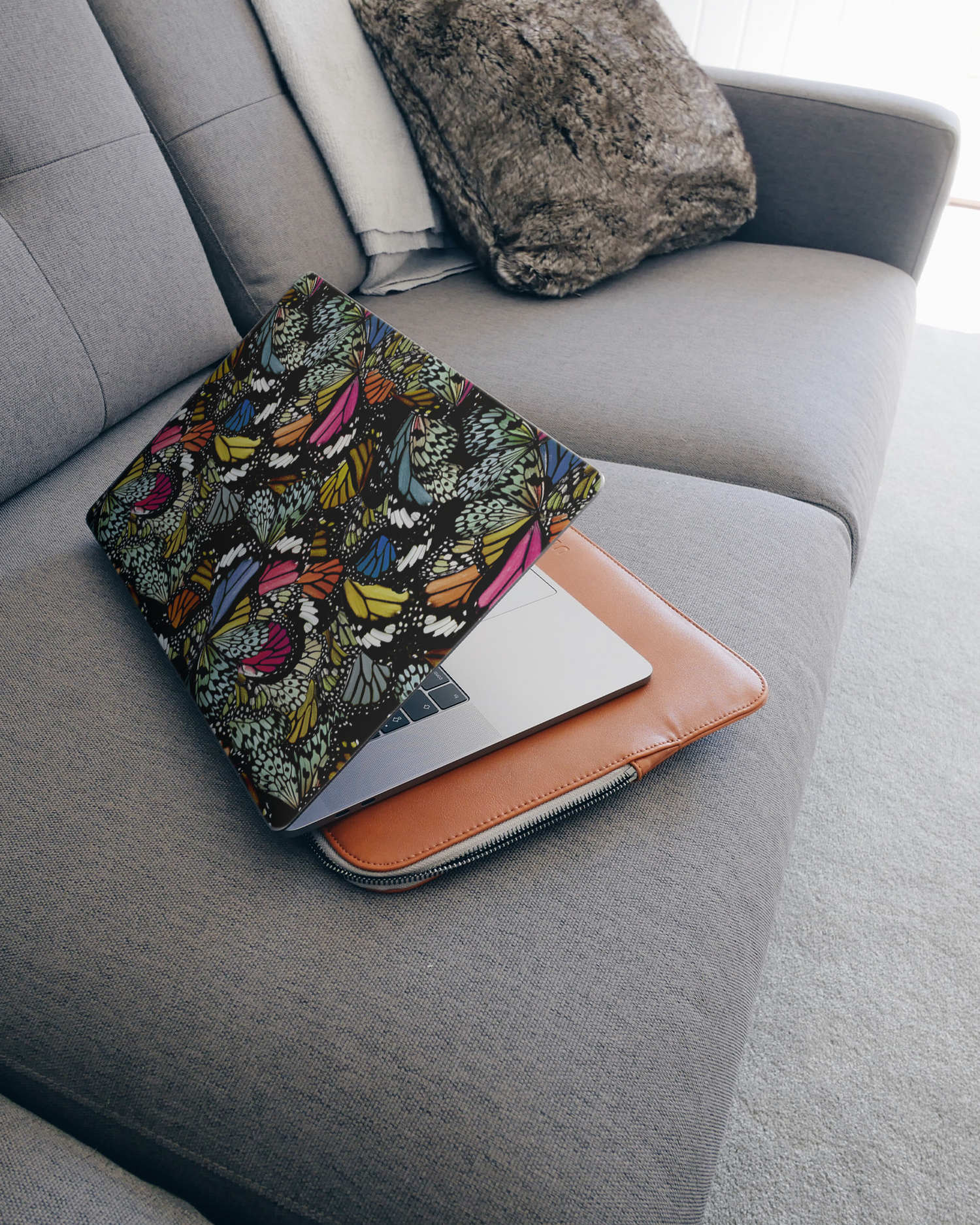 Psychedelic Butterflies Laptop Skin for 15 inch Apple MacBooks on a couch