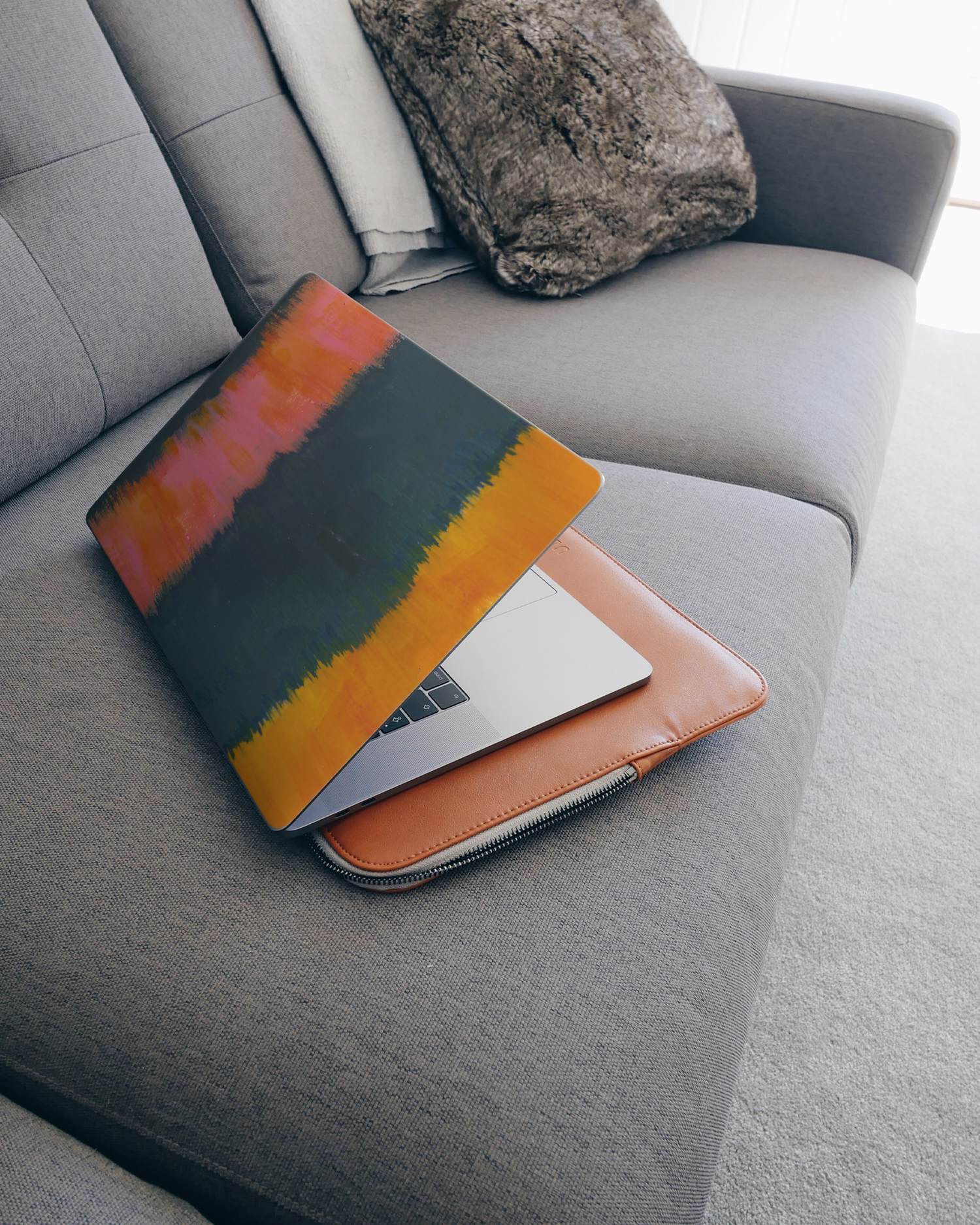 Ombre Gradient Laptop Skin for 15 inch Apple MacBooks on a couch