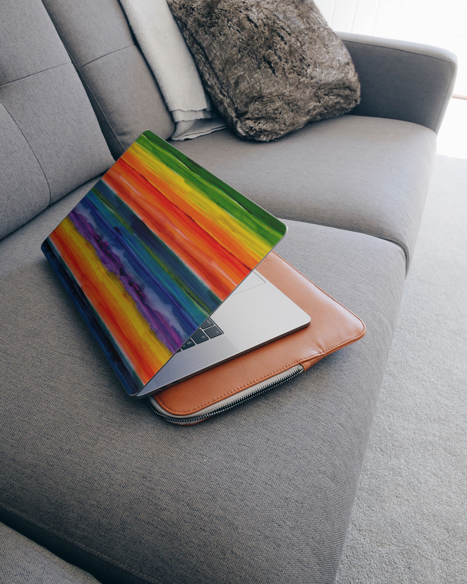 Striped Tie Dye Laptop Skin for 15 inch Apple MacBooks on a couch