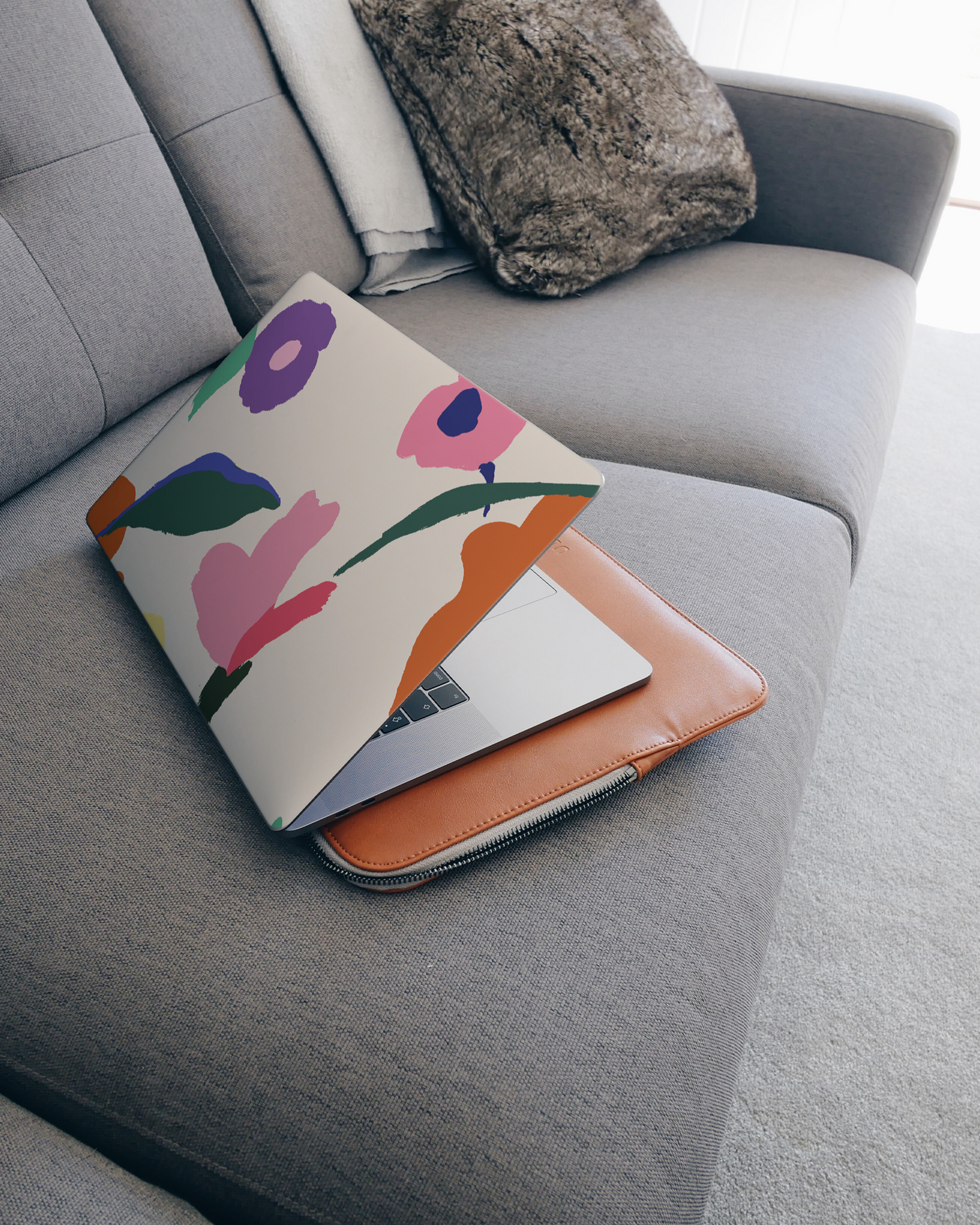 Handpainted Blooms Laptop Skin for 15 inch Apple MacBooks on a couch