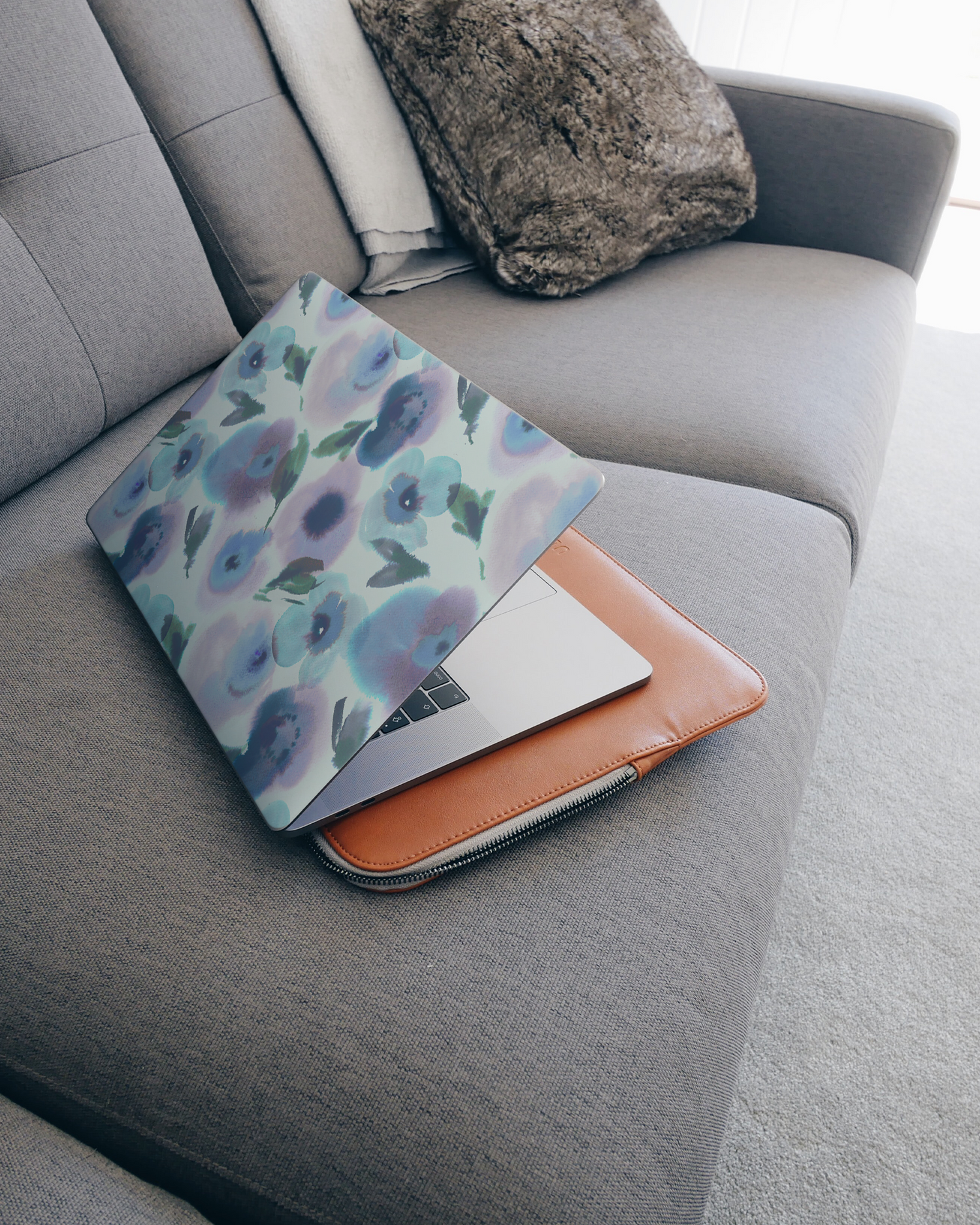 Watercolour Flowers Blue Laptop Skin for 15 inch Apple MacBooks on a couch