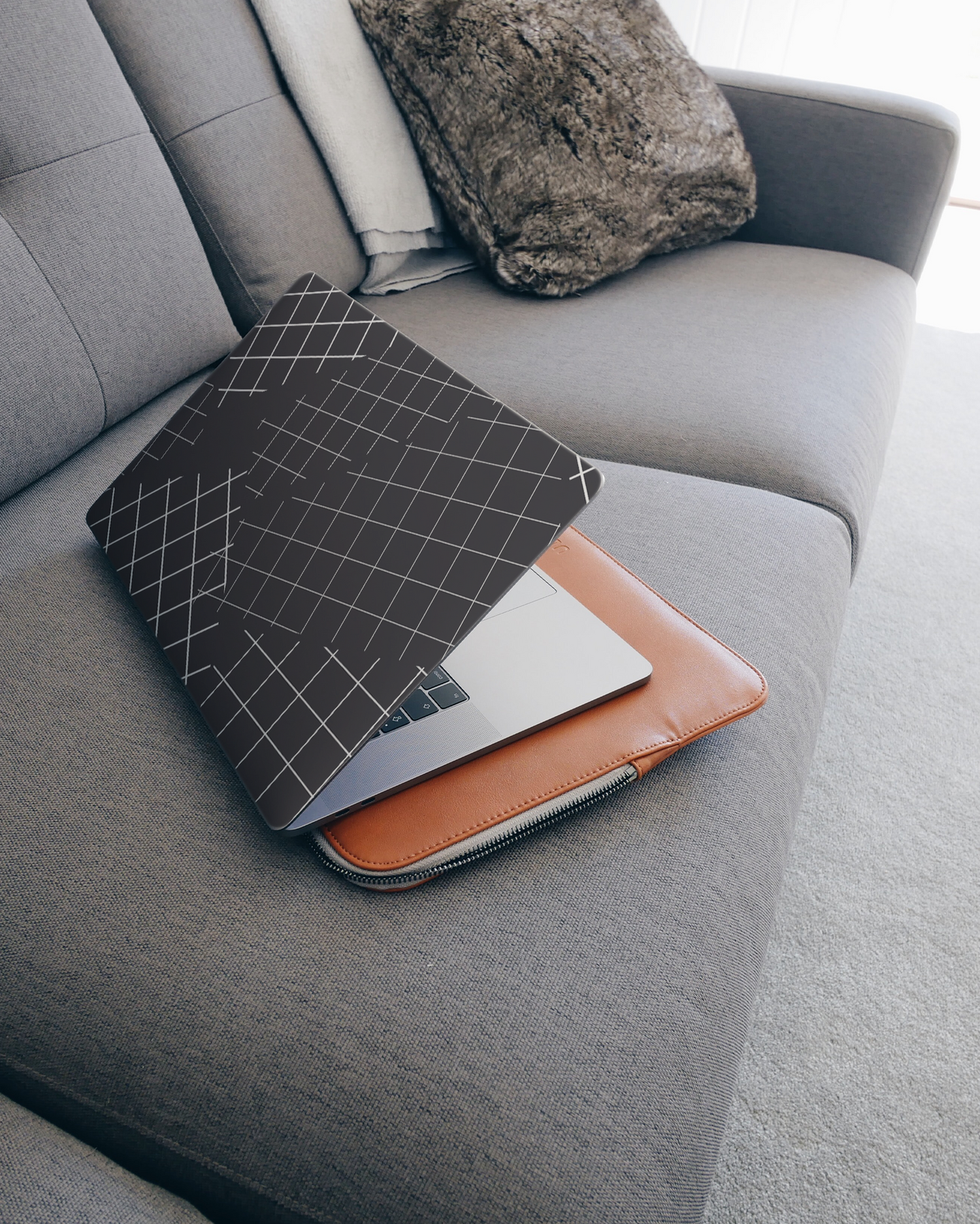 Grids Laptop Skin for 15 inch Apple MacBooks on a couch