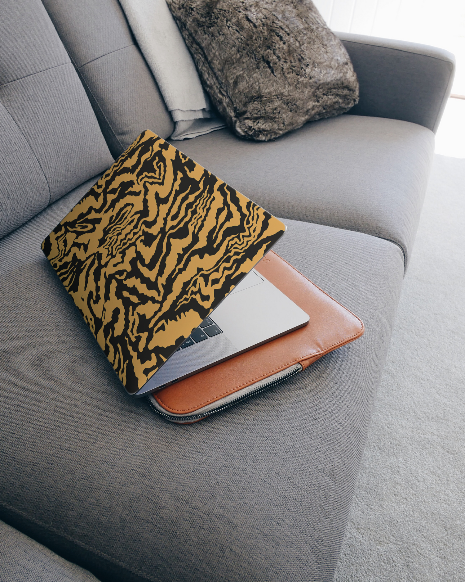 Warped Tiger Stripes Laptop Skin for 15 inch Apple MacBooks on a couch