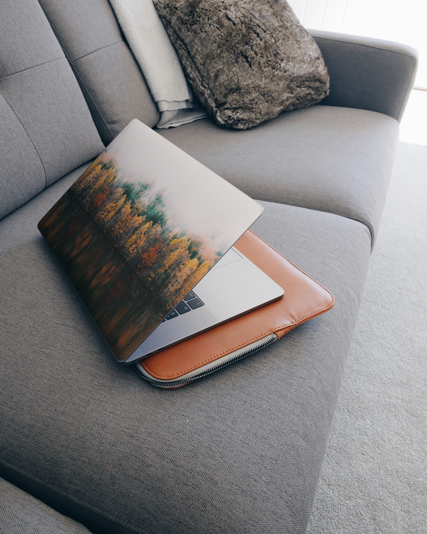 Fall Fog Laptop Skin for 15 inch Apple MacBooks on a couch