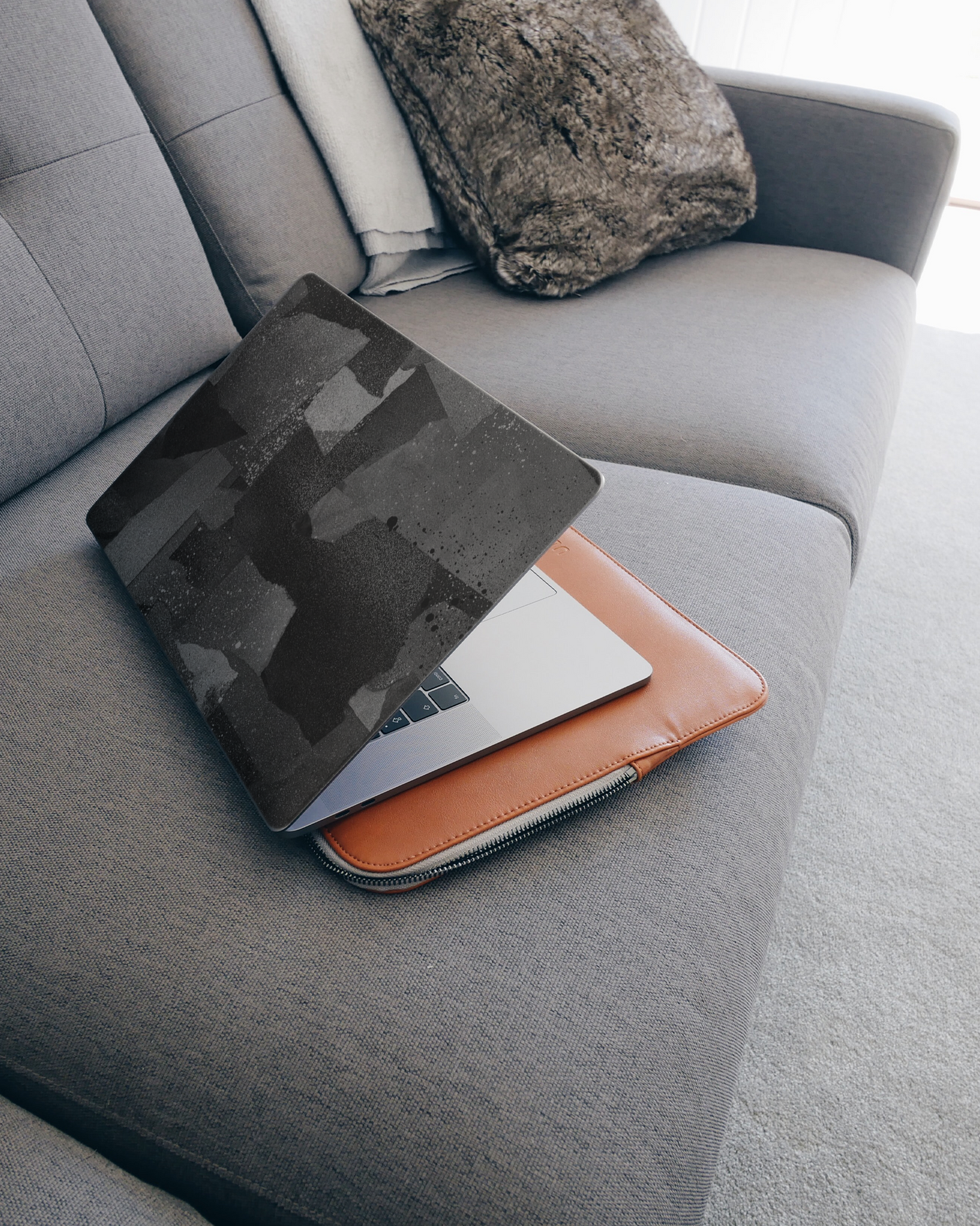 Torn Paper Collage Laptop Skin for 15 inch Apple MacBooks on a couch
