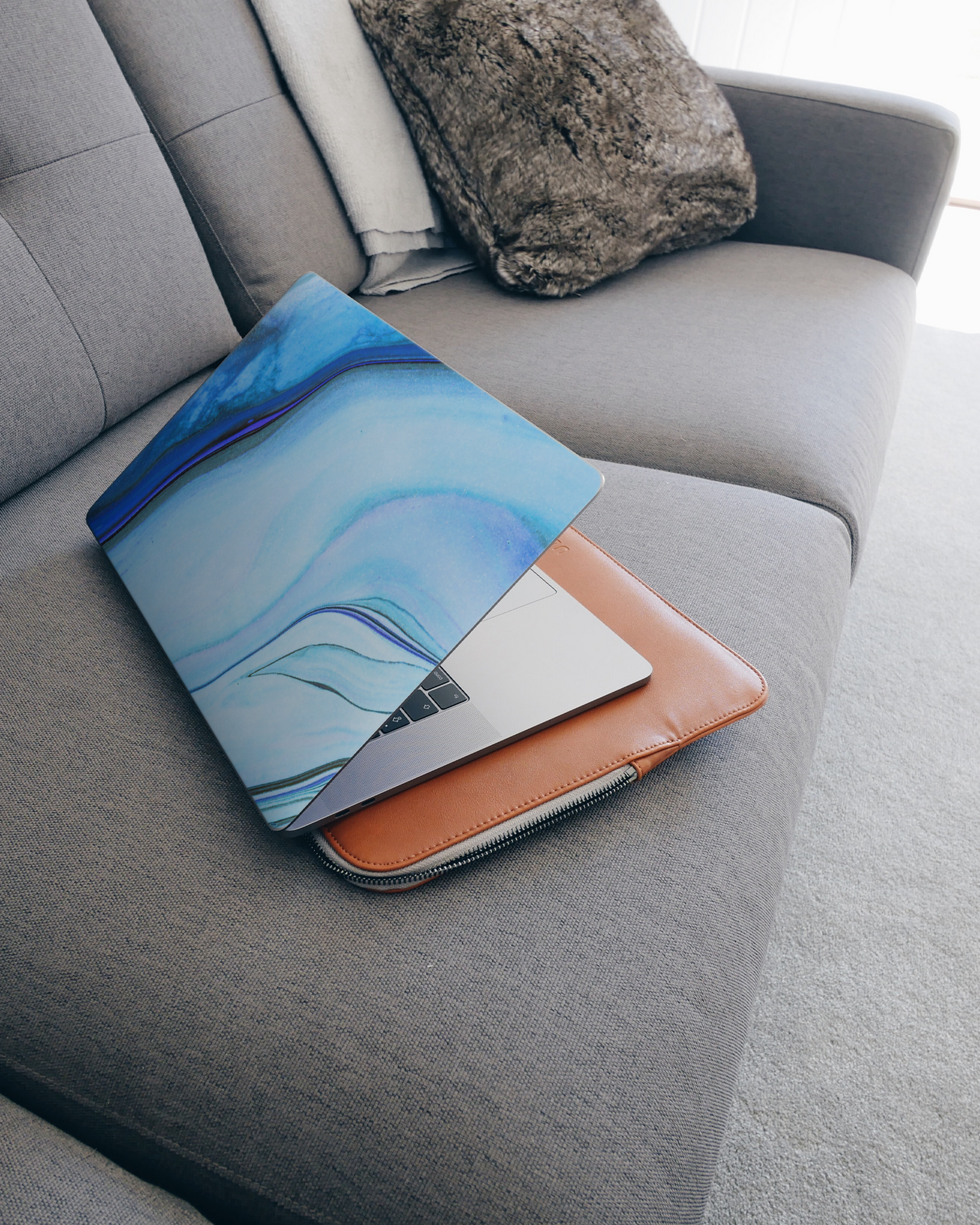 Cool Blues Laptop Skin for 15 inch Apple MacBooks on a couch
