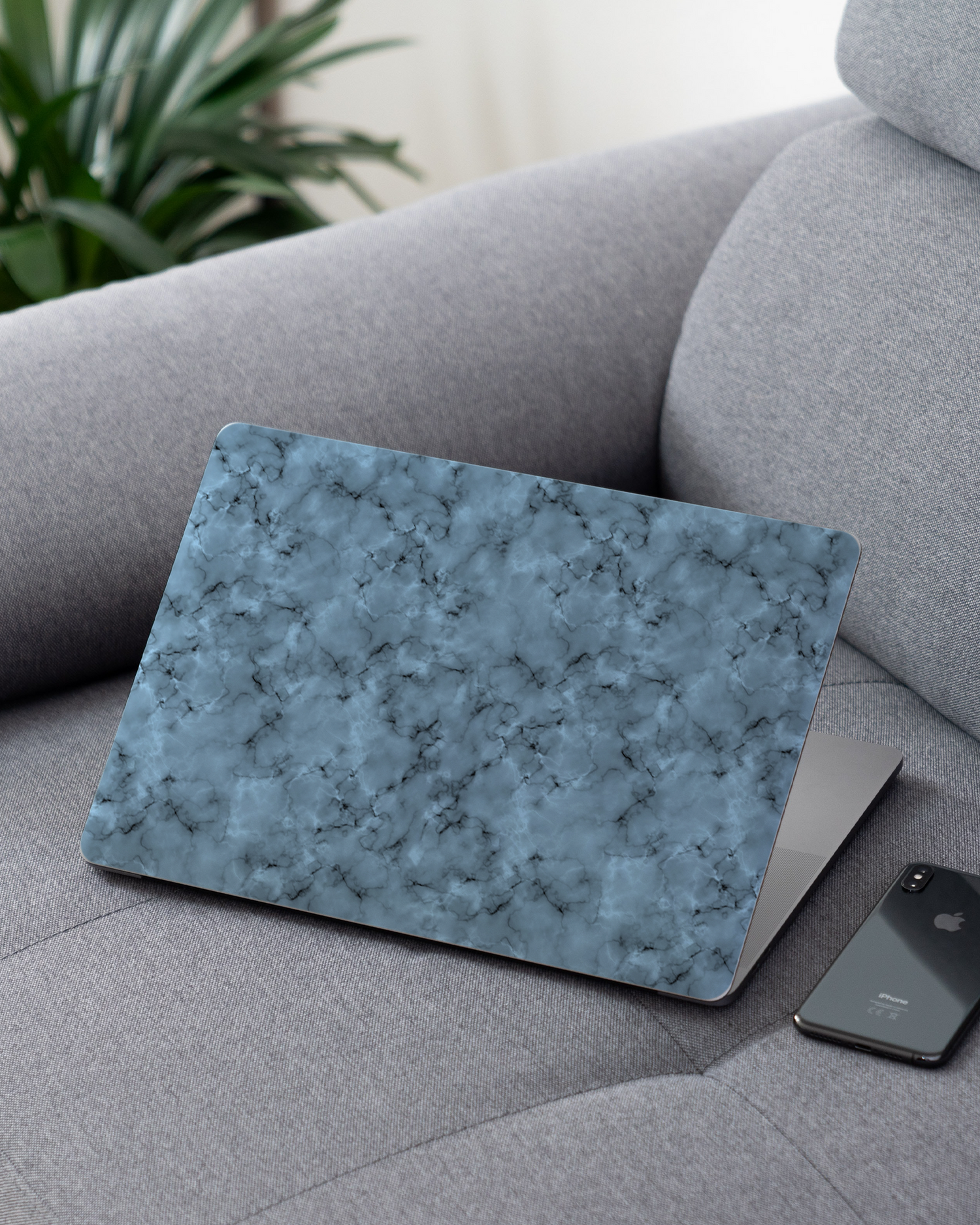 Blue Marble Laptop Skin for 13 inch Apple MacBooks on a couch