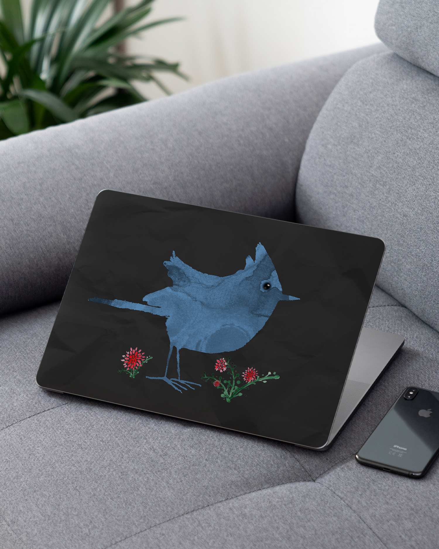 Watercolour Bird Black Laptop Skin for 13 inch Apple MacBooks on a couch