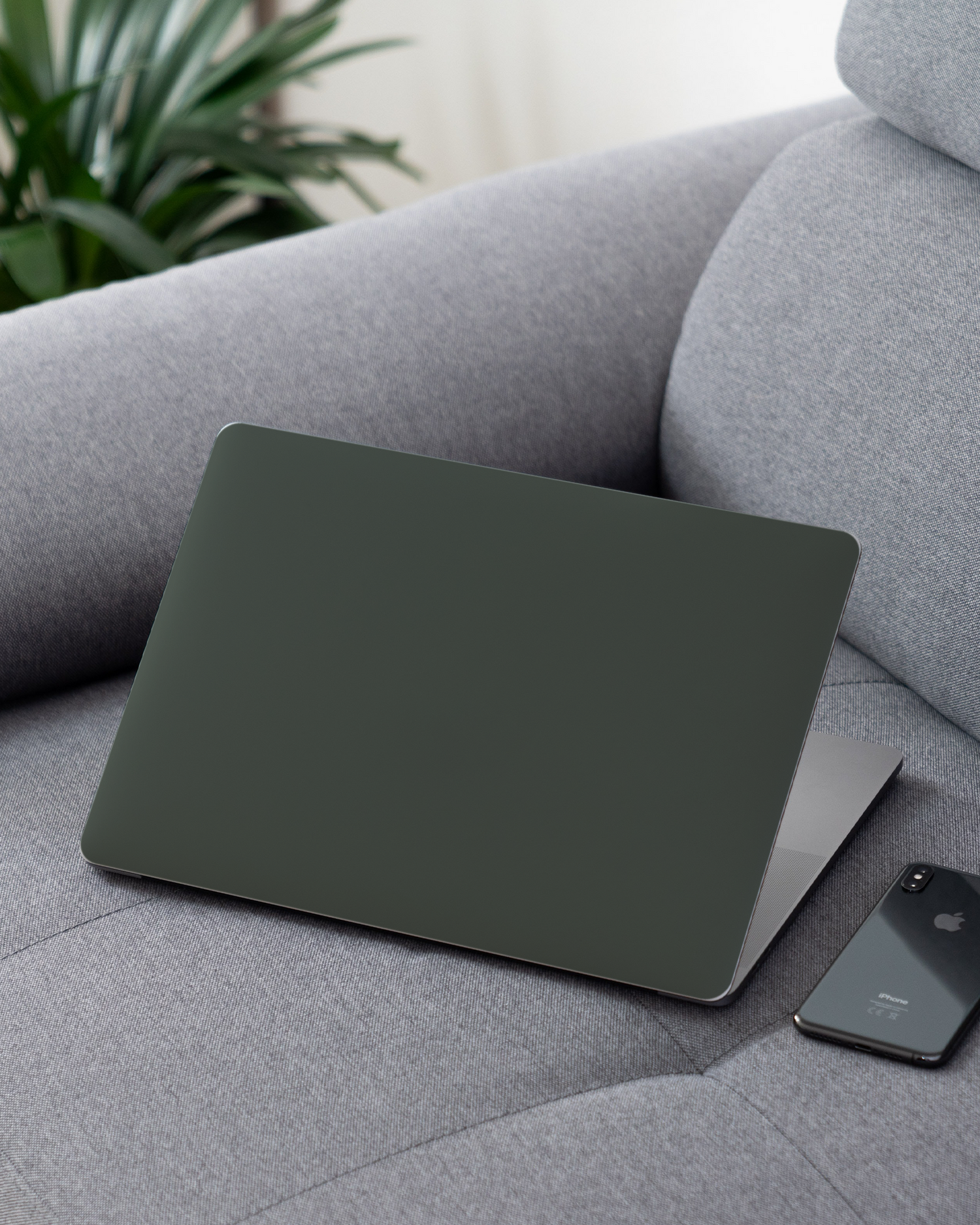 MIDNIGHT GREEN Laptop Skin for 13 inch Apple MacBooks on a couch