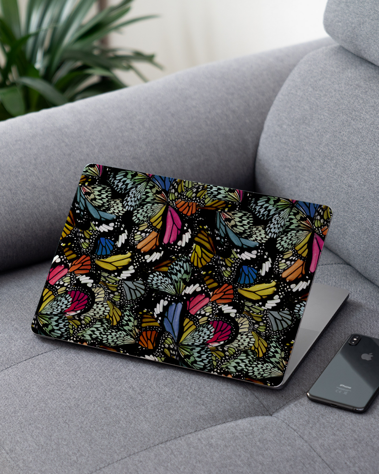 Psychedelic Butterflies Laptop Skin for 13 inch Apple MacBooks on a couch
