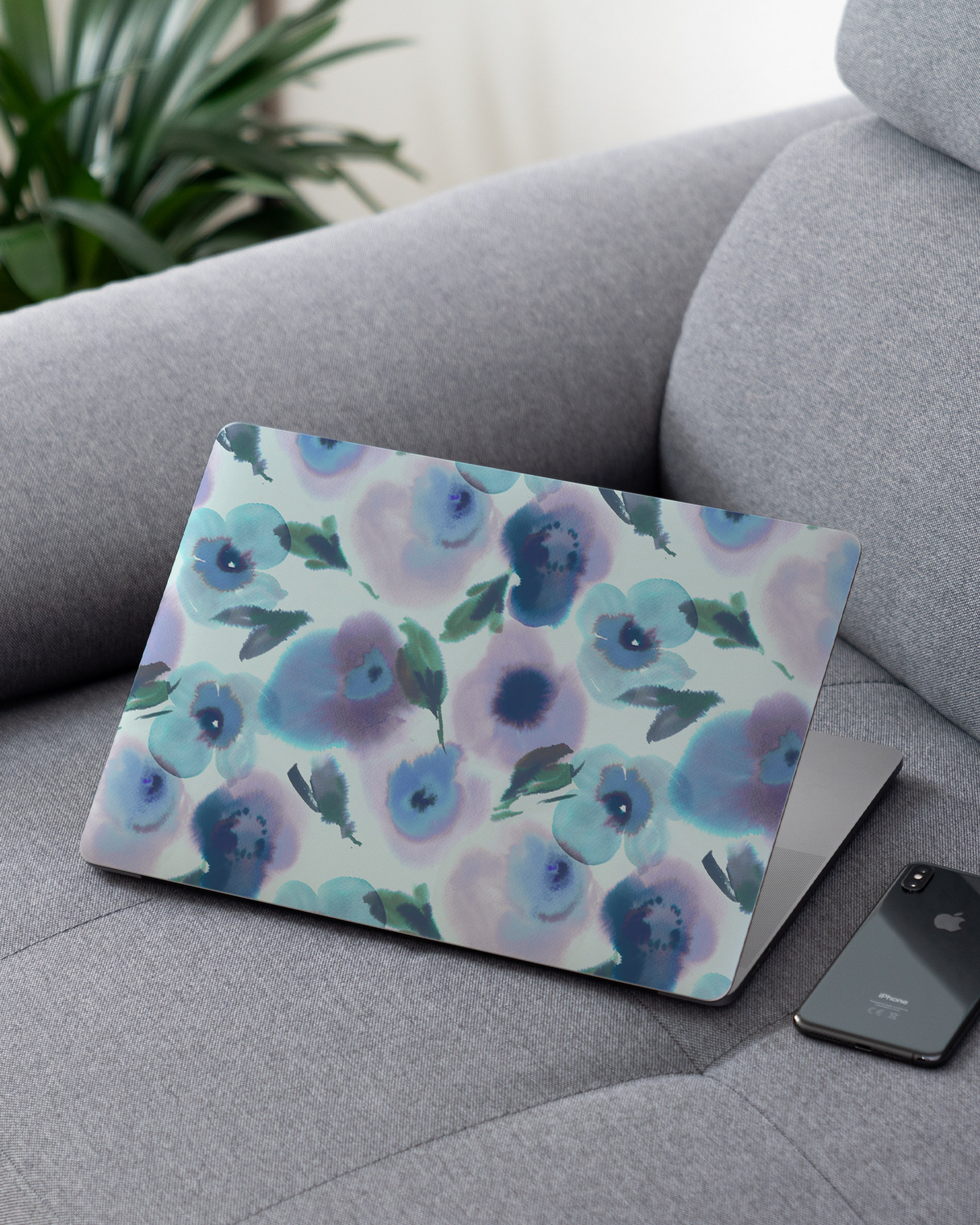 Watercolour Flowers Blue Laptop Skin for 13 inch Apple MacBooks on a couch