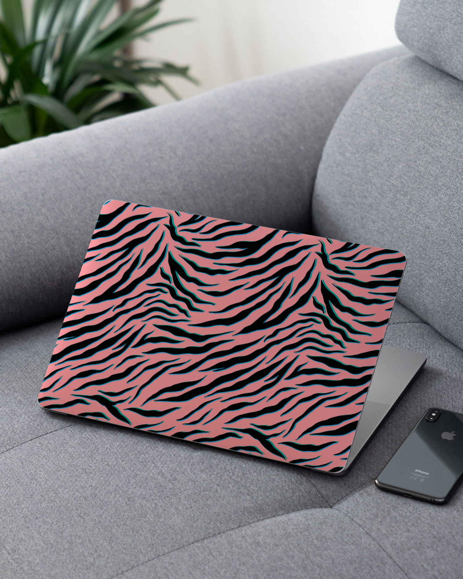 Pink Zebra Laptop Skin for 13 inch Apple MacBooks on a couch