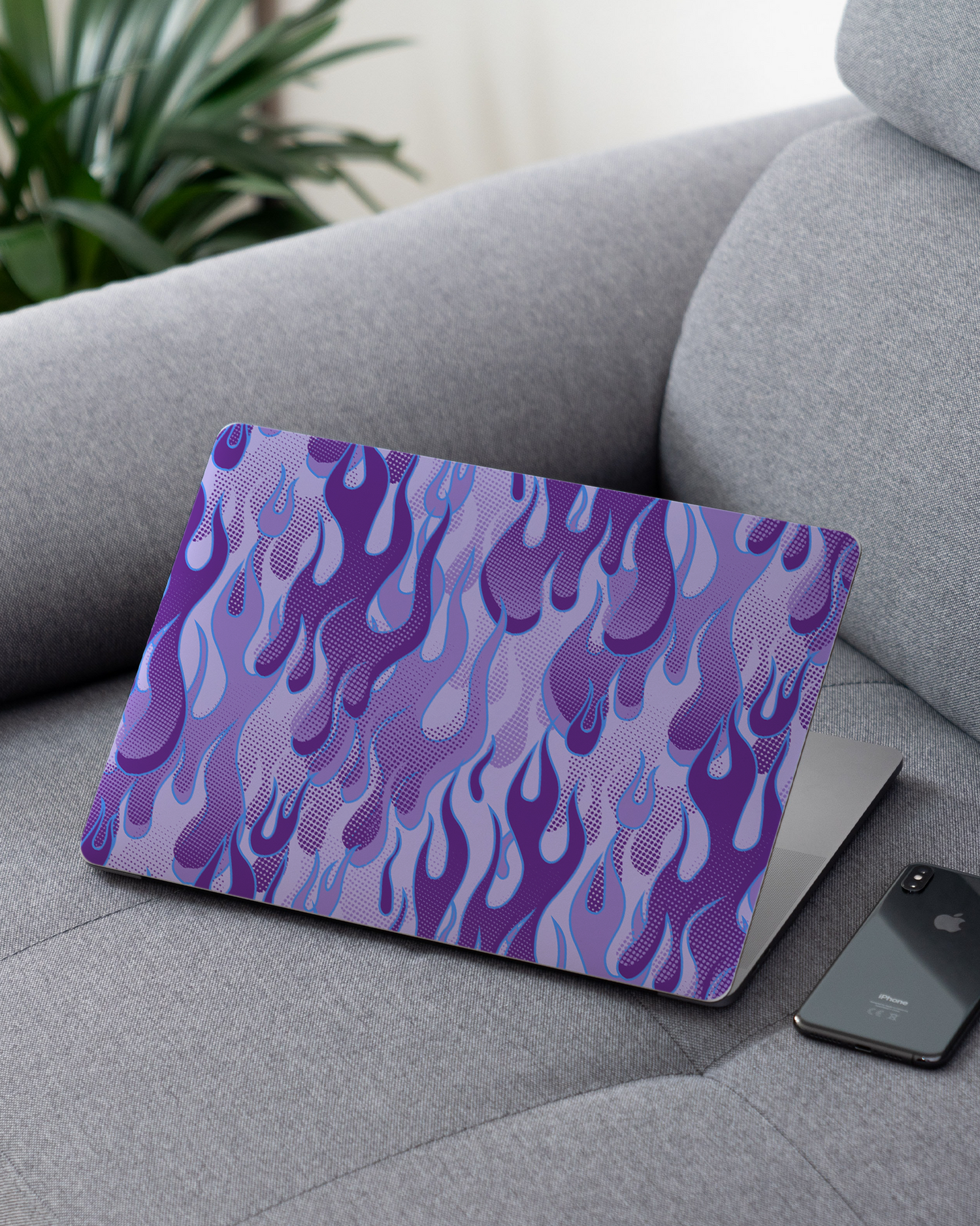 Purple Flames Laptop Skin for 13 inch Apple MacBooks on a couch